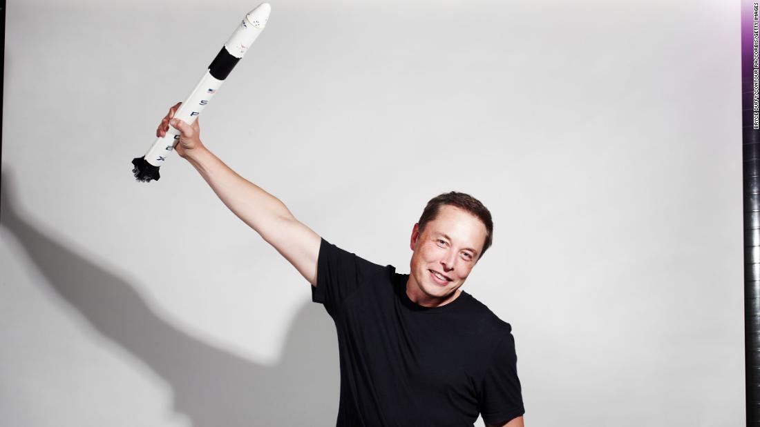 Musk holds up a model rocket in this photo for Bloomberg Businessweek magazine in 2012.