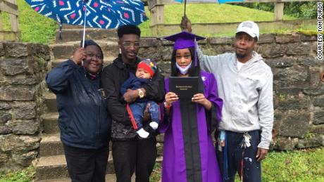 Takela Thomas and her family celebrate her high school graduation in front of their home.