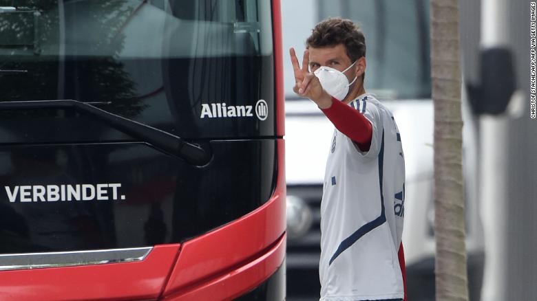 Bayern Munich striker Thomas Mueller wears a face mask as he leaves a training session.