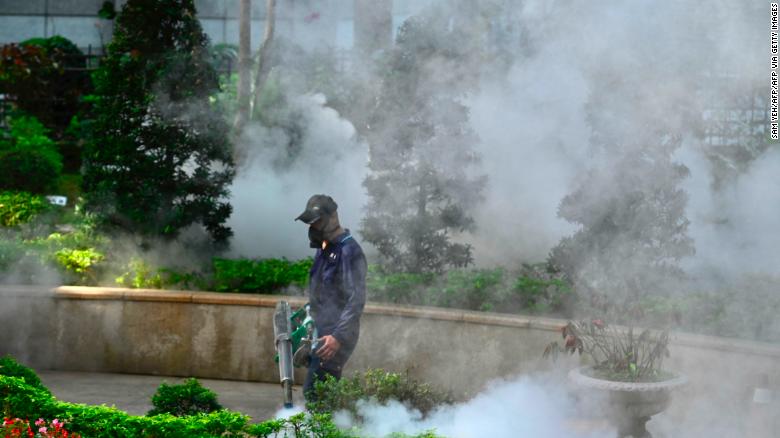 A mask-clad worker disinfects a park to prevent the spread of the coronavirus in New Taipei City on March 9.