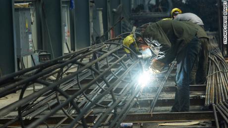 An employee works on steel bars at a factory in Hangzhou, in China&#39;s eaastern Zhejiang province on May 15, 2020.