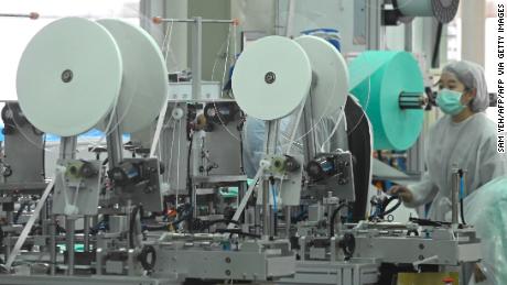 A staff of Taiwans Universal Incorporation, one of the major mask maker, operates machines at a factory in Tainan, southern Taiwan.