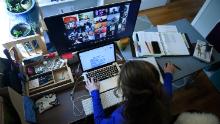 A substitute teacher works from her home in Arlington, Virginia, using Zoom to communicate with students and their families. (Olivier Douliery/AFP/Getty Images)
