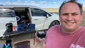 Walter Kinzie works out of his wife's minivan on a farm in South Dakota.