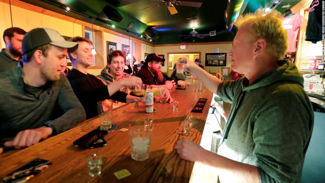 Owner Michael Mattson toasts the re-opening of the Friends and Neighbors bar in Appleton, Wisconsin, following the Wisconsin Supreme Court&#39;s decision &lt;a href=&quot;https://www.cnn.com/2020/05/13/politics/wisconsin-supreme-court-strikes-down-stay-at-home-order/index.html&quot; target=&quot;_blank&quot;&gt;to strike down the state&#39;s stay-at-home order&lt;/a&gt; on May 13.