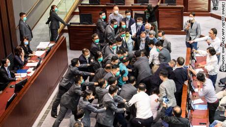 Hong Kong lawmakers scuffle as pro-Beijing politicians clear path for controversial national anthem bill