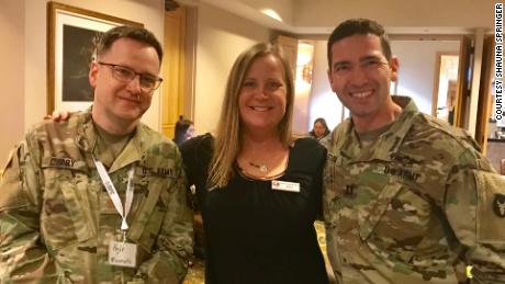 On Springer&#39;s left is Eric Strom, a Licensed Clinical Social Worker who is a Behavioral Health Officer in the Army National Guard. On her right is psychologist Kyle Curry, also in the Army National Guard.
