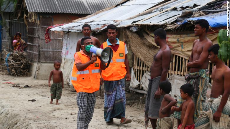 A volunteer urges residents to evacuate to shelters ahead of the expected landfall of the cyclone in Khulna, Bangladesh, on May 19.