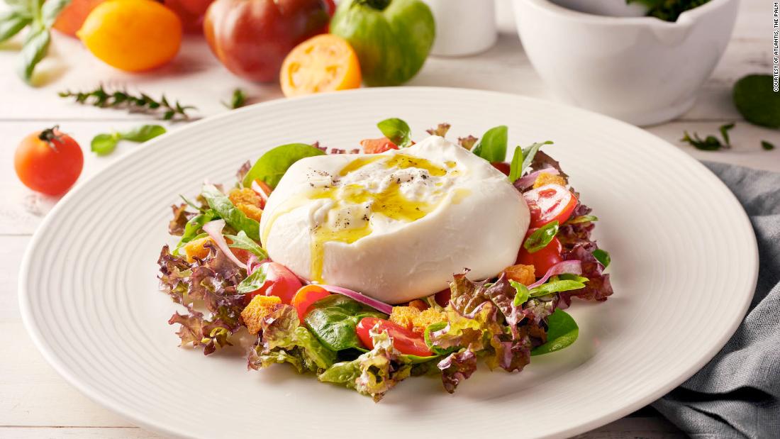 Fresh cow&#39;s milk burrata cheese from Ronda Locatelli comes with panzanella salad, cherry tomatoes and red onion.