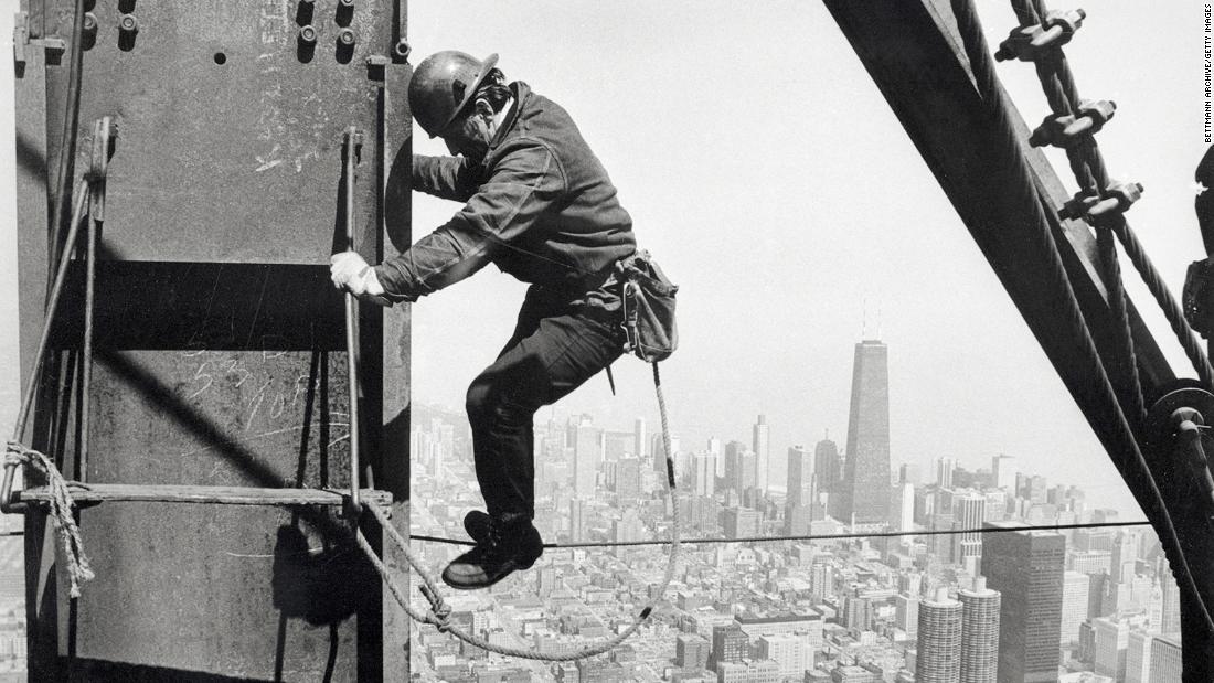 An iron worker helps construct the Sears Tower in Chicago. Sears&#39; new headquarters, built in 1973, was the world&#39;s tallest building until 1998. Sears sold the building in 1994.