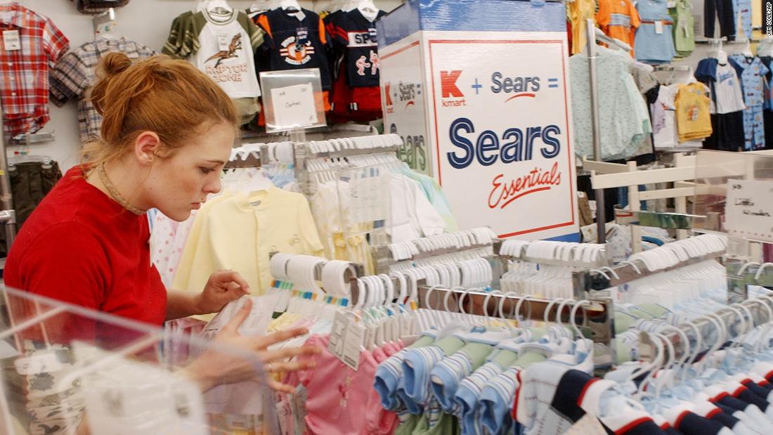 Kaylin Wilson sets up children&#39;s clothes in a Kmart in Nashua, New Hampshire, in 2005. The store was the first Kmart in the country to begin receiving Sears merchandise after stockholders voted on a merger to form the nation&#39;s third largest retailer.