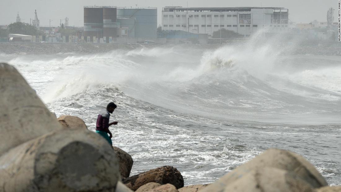 A man looks out at waves in Chennai, India, on May 19.