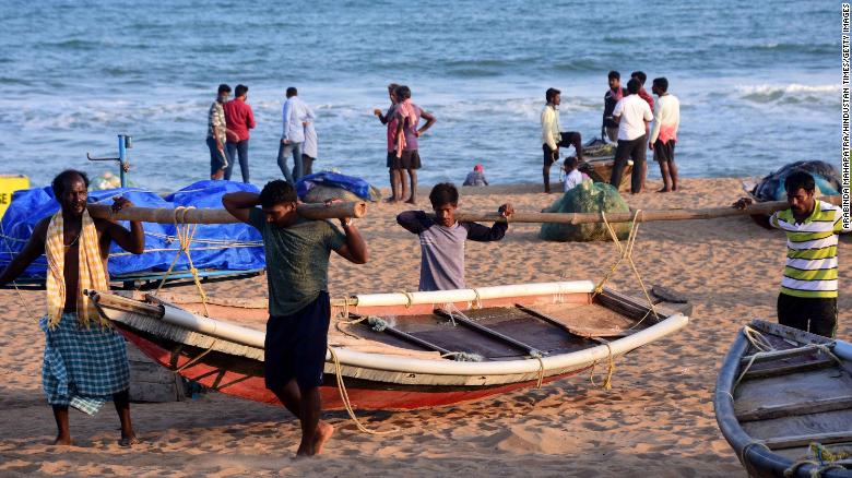 Fishermen bringing in their boats after warnings were sounded ahead of the cyclone&#39;s arrival on May 18 in Puri, India.