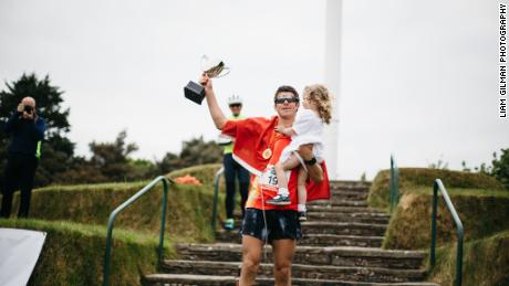 Christian Varley celebrates with his daughter after completing his 19th marathon.