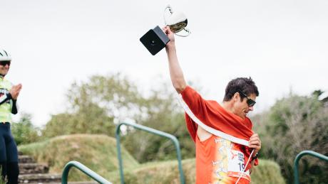 Christian Varley celebrates finishing his 19th marathon in as many days.