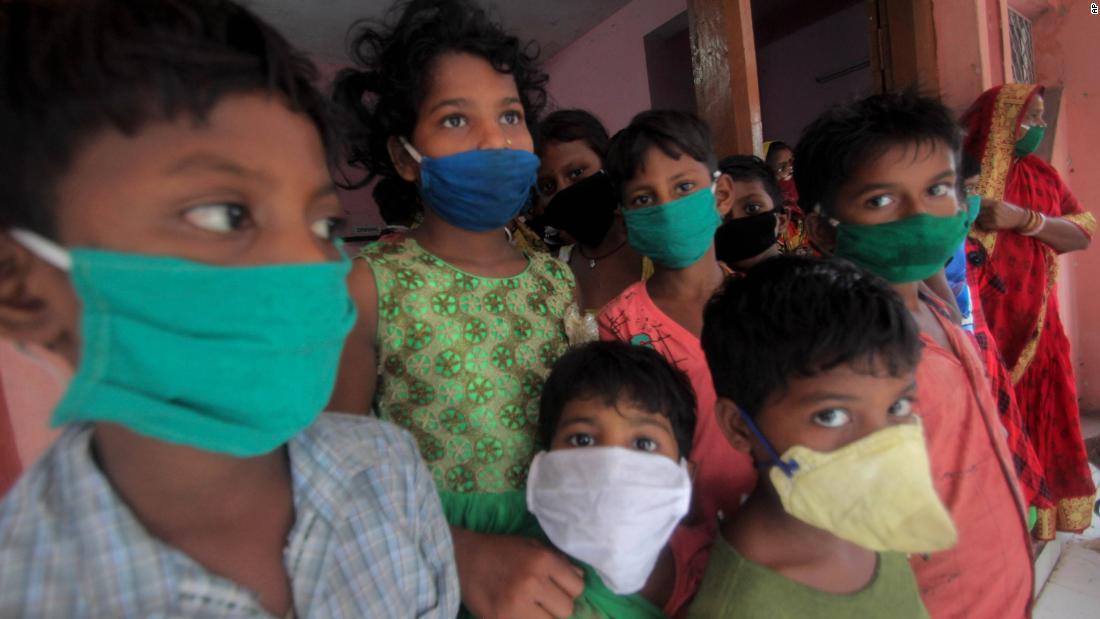 Children wear face masks at a relief camp in Paradeep, India.