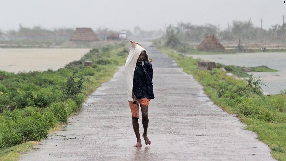 A man walks in the rain in India&#39;s Bhadrak district.