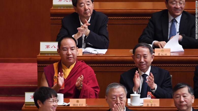 The Chinese government-selected 11th Panchen Lama Gyaincain Norbu (middle row left) applauds during a plenary session of the Chinese People&#39;s Political Consultative Conference in Beijing on March 10, 2019.
