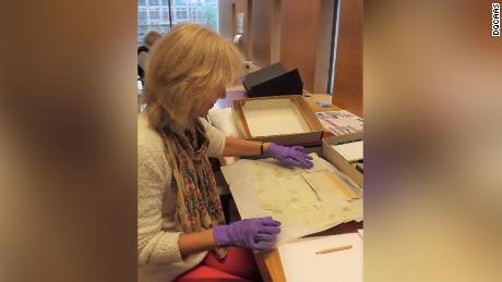 Professor Joan Taylor examining the Dead Sea Scrolls fragments. 