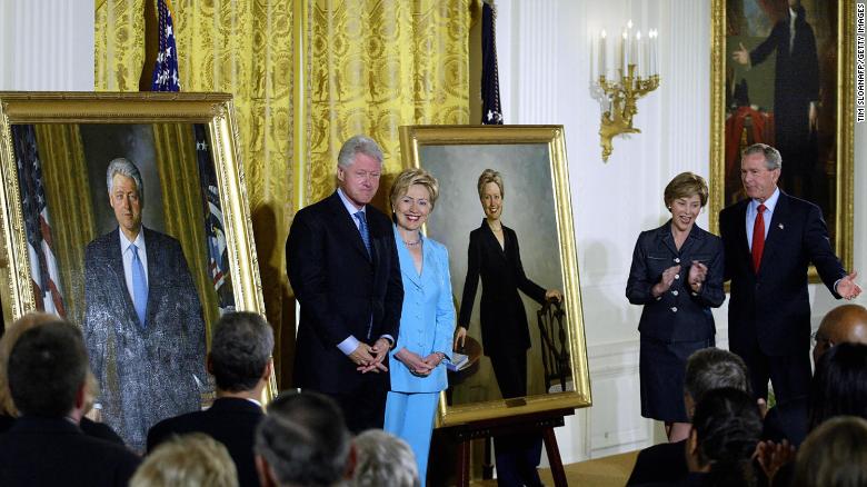 Former US President Bill Clinton (L) and Senator Hillary Clinton (2nd-L) stand by their offical White House portraits during the unveiling event hosted by President George W. Bush (R) and First Lady Laura Bush (2nd-R) 14 June, 2004 in the East Room of the White House  in Washington, DC. 