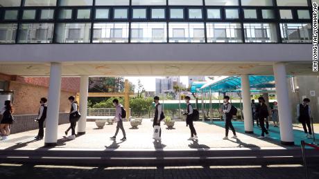 Senior students maintain social distancing as they arrive at Hamwol High School in Ulsan, South Korea, Wednesday, May 20, 2020.