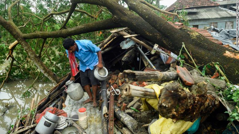 A man salvages items from his house damaged by Cyclone Amphan in Midnapore, West Bengal, on May 21, 2020. 