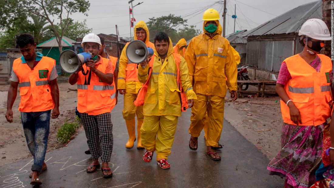 Volunteers of the Cyclone Preparedness Program use a megaphone to urge residents to evacuate Dacope, Bangladesh, on May 20.