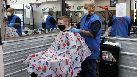 Larry Love, manager at Hair Doctors in Anchorage, Alaska, gives an airman a haircut on  April 27.