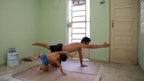Photographer Bénédicte Desrus and his son Thiago  do yoga together during the pandemic in Mérida, Yucatán, Mexico.