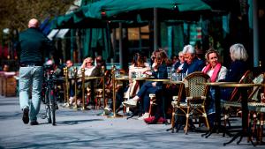 People sit in a restaurant in Stockholm on May 8, 2020, amid the coronavirus COVID-19 pandemic. (Photo by Jonathan NACKSTRAND / AFP) (Photo by JONATHAN NACKSTRAND/AFP via Getty Images)