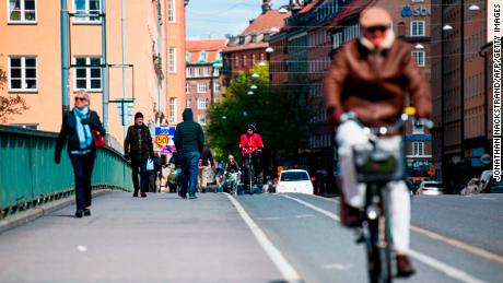 Pedestrians and cyclists cross a bridge in the heart of Stockholm on May 11.