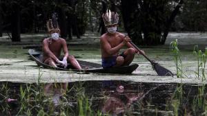 Satere-mawe indigenous men navigate the Ariau river during the COVID-19 novel coronavirus pandemic at the Sahu-Ape community, 80 km of Manaus, Amazonas State, Brazil, on May 5, 2020. - The Brazilian state of Amazonas, home to most of the country's indigenous people, is one of the regions worst affected by the pandemic, with more than 500 deaths to date according to the health ministry. (Photo by RICARDO OLIVEIRA / AFP) (Photo by RICARDO OLIVEIRA/AFP via Getty Images)