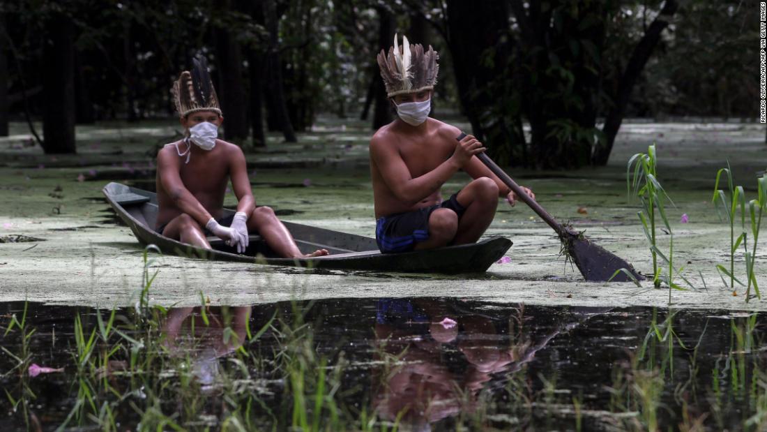 Satere-mawe indigenous men navigate the Ariau river during the COVID-19 novel coronavirus pandemic at the Sahu-Ape community, 80 km of Manaus, Amazonas State, Brazil, on May 5, 2020. 