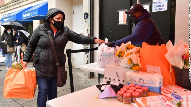 A volunteer distributes child-care essentials to families in need at a Food Bank For New York City pantry.