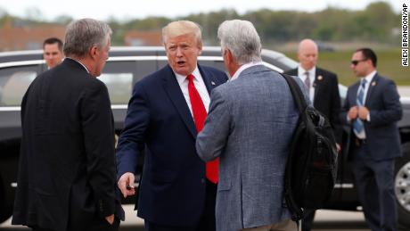 President Donald Trump speaks with White House chief of staff Mark Meadows, left, and Fox News correspondent John Roberts before boarding Air Force One as he departs Detroit Metro Airport, Thursday, May 21, 2020, in Detroit. Trump visited a Ypsilanti, Mich., Ford plant that has been converted to making personal protection and medical equipment. (AP Photo/Alex Brandon)