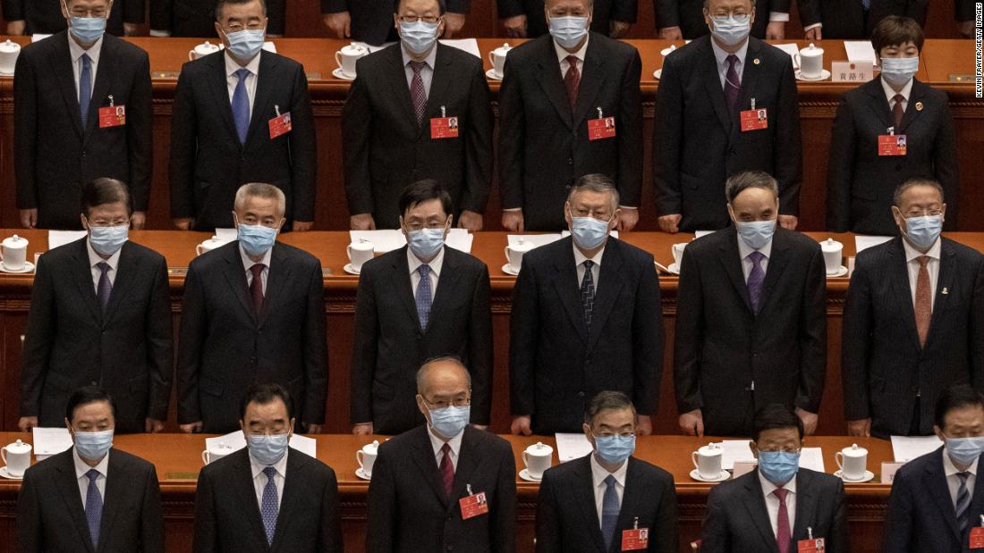 Chinese Communist Party delegates stand for the national anthem at the opening of the National People&#39;s Congress on May 22. The annual parliamentary gathering had been postponed.