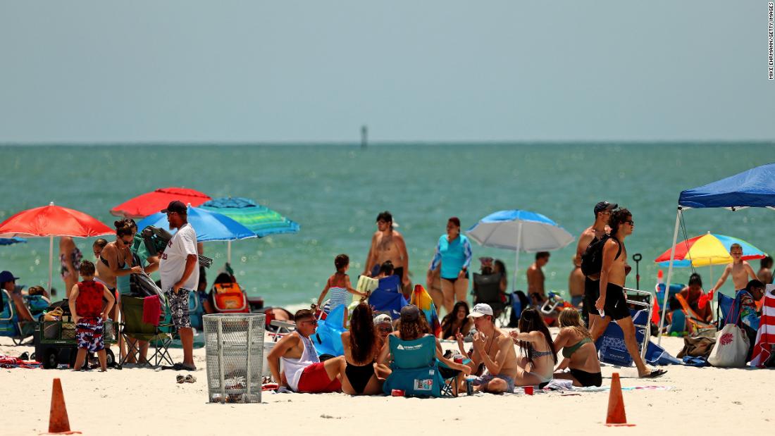 People visit Florida&#39;s Clearwater Beach on May 20. Florida opened its beaches as part of Phase One of its reopening.