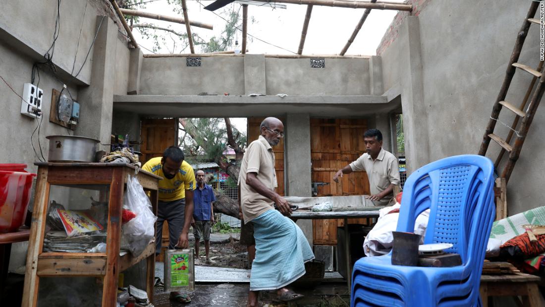 Men salvage items from a damaged shop in West Bengal on Thursday, May 21.