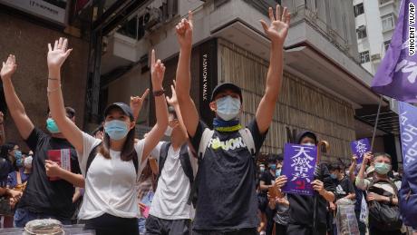 Protesters gesture with five fingers, signifying the &quot;Five demands - not one less&quot; during a pro-democracy protest against Beijing&#39;s national security legislation in Hong Kong on May 24, 2020. 