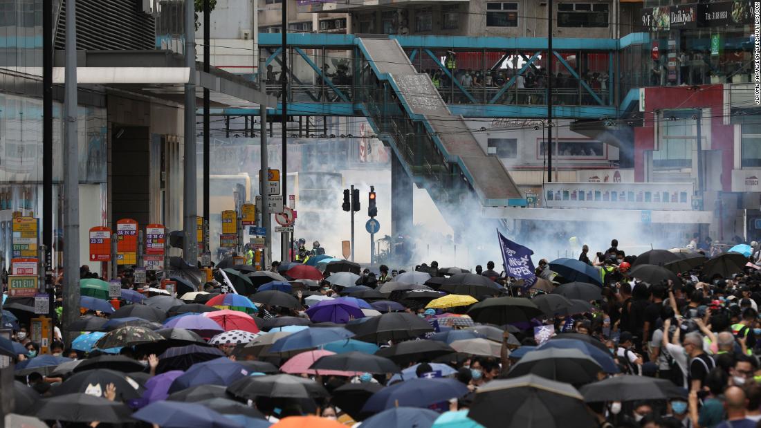 Tear gas is seen in the background as police try to disperse protesters on May 24.