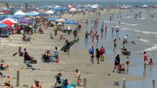 Beachgoers gather in Port Aransas, Texas, on Saturday as Americans head to the coasts this weekend.