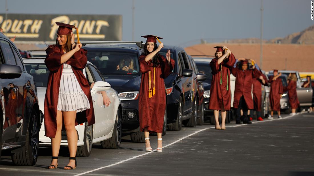 High school graduates turn their tassels during a drive-thru graduation ceremony at the Las Vegas Motor Speedway.