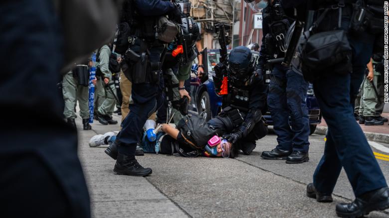 A protester is detained by riot police in Hong Kong on May 24.