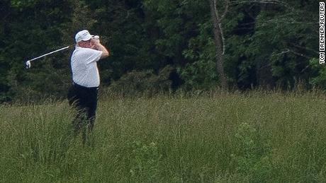 U.S. President Donald Trump swings a golf club during a round of golf, amid the coronavirus disease (COVID-19) outbreak, in Sterling, Virginia, U.S., May 24, 2020. REUTERS/Tom Brenner