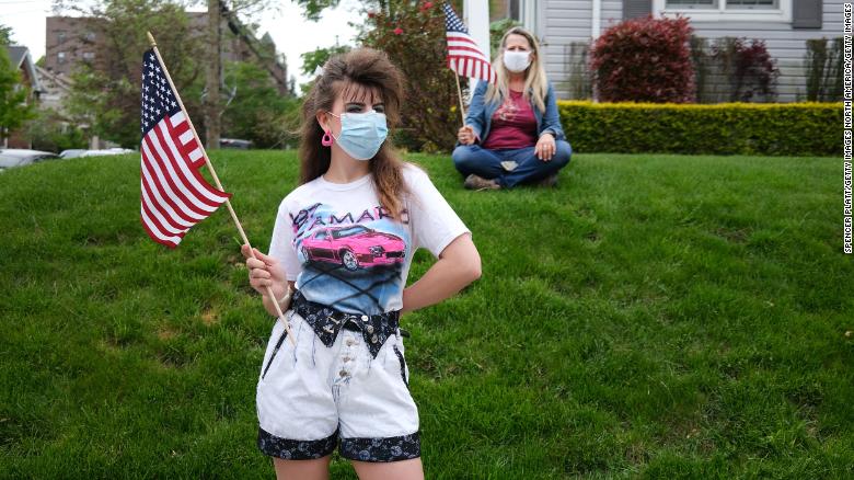 People wear face masks while participating in the annual Memorial Day Parade in Staten Island, New York, on Monday, May 25.