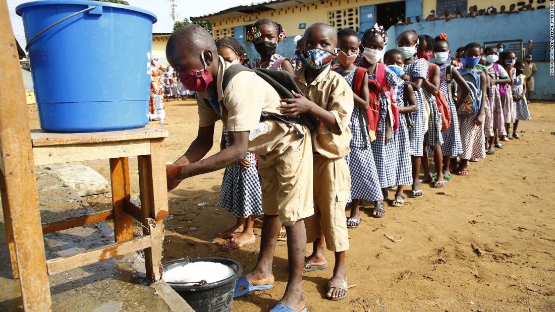 Preschool students wait to wash their hands before class in Abidjan, Ivory Coast, on May 25, 2020. The country became one of the first in West Africa to restart lessons after a two-month coronavirus shutdown. 