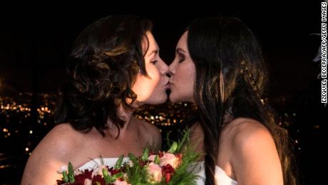 Alexandra Quiros and Dunia Araya kiss during their wedding Tuesday in Costa Rica.