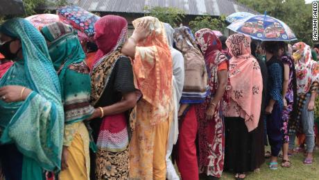 Women queue up to receive an aid delivery at the Daulatdia brothel in Bangladesh on May 14.