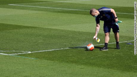A English Premier League Nike Ball is sprayed with disinfectant during a training session at Sir Jack Hayward Training Ground on May 20 in Wolverhampton, England.