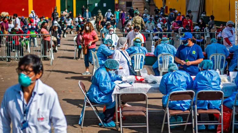 Health Ministry workers prepare to carry out coronavirus tests for employees of the Ciudad de Dios market in Lima, Peru on May 11.